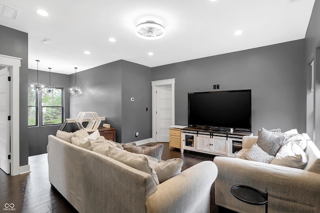 living room featuring a chandelier and dark hardwood / wood-style flooring