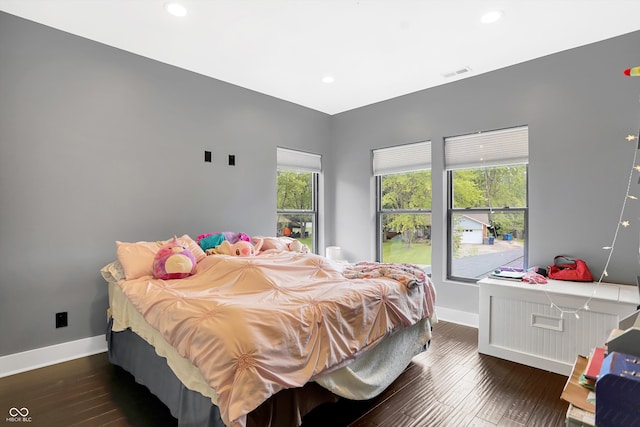 bedroom with dark hardwood / wood-style flooring