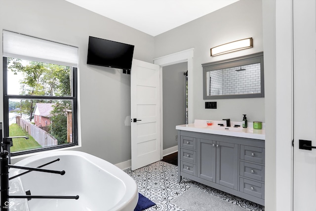 bathroom featuring a bath, tile patterned floors, and vanity