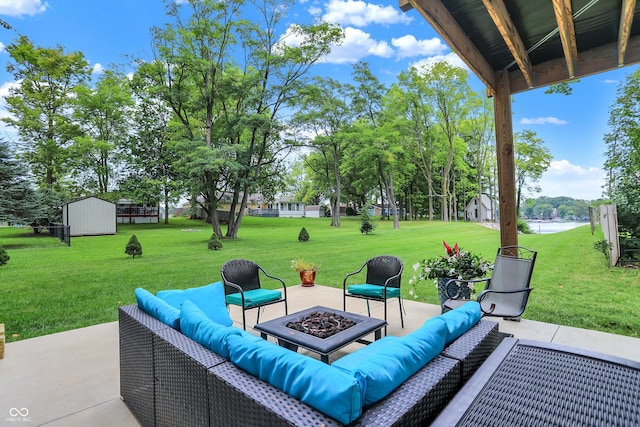 view of patio featuring an outdoor living space with a fire pit and a storage unit