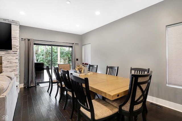 dining space with dark hardwood / wood-style flooring