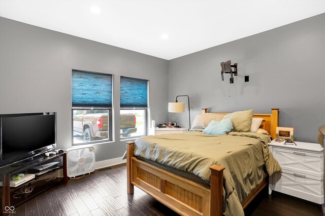 bedroom with dark hardwood / wood-style floors