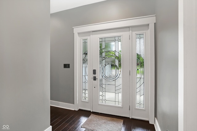 foyer entrance with dark hardwood / wood-style floors