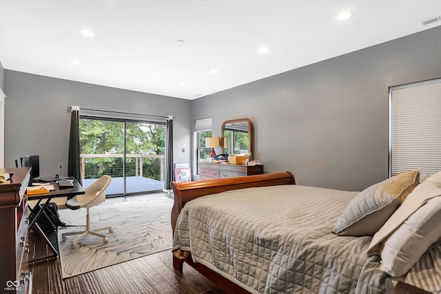 bedroom featuring hardwood / wood-style flooring and access to exterior