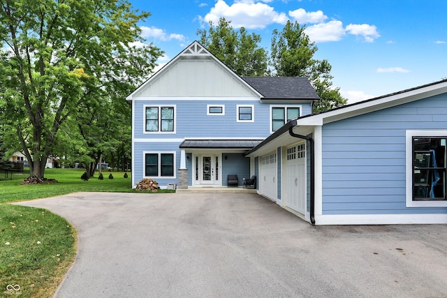 view of front of house with a garage and a front lawn