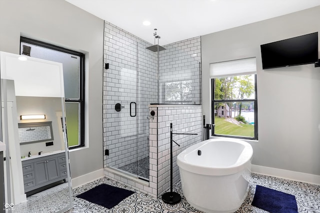 bathroom featuring separate shower and tub, tile patterned flooring, and vanity