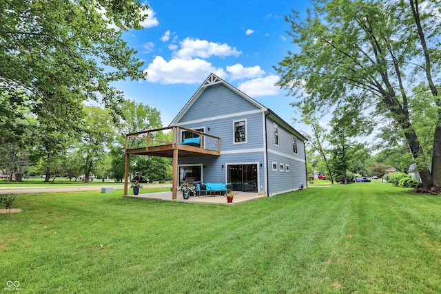 back of property with a lawn and a patio area