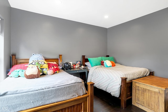 bedroom with dark hardwood / wood-style floors