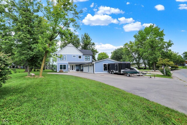 view of front of home with a garage and a front yard