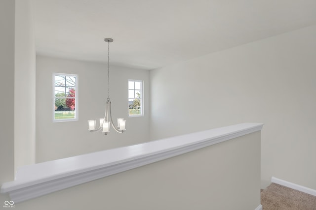 interior details featuring an inviting chandelier