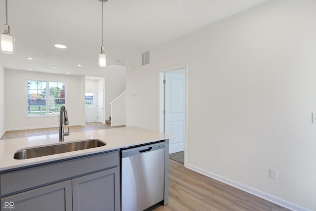 kitchen featuring gray cabinetry, dishwasher, pendant lighting, and sink