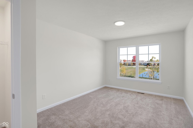 empty room featuring light colored carpet