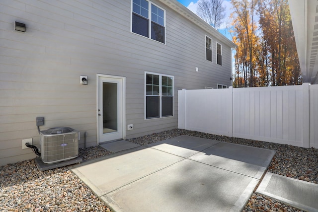 rear view of property with cooling unit and a patio area