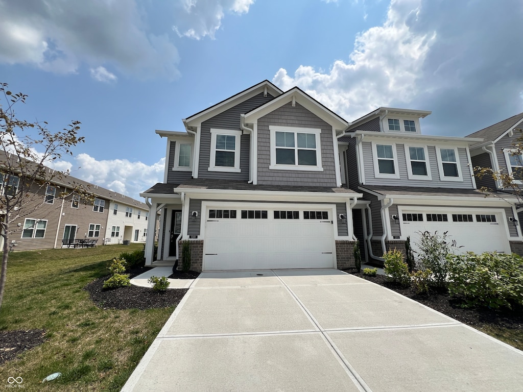 view of front of home with a front lawn and a garage