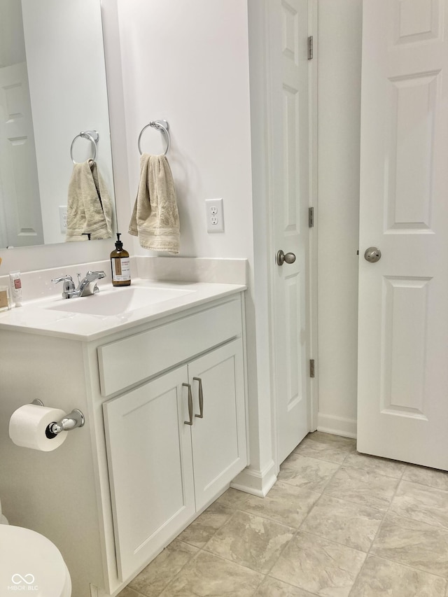 bathroom featuring a closet and vanity