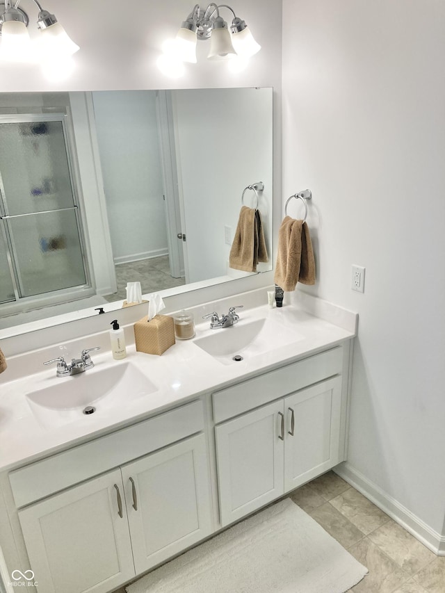 bathroom featuring a sink, baseboards, and double vanity