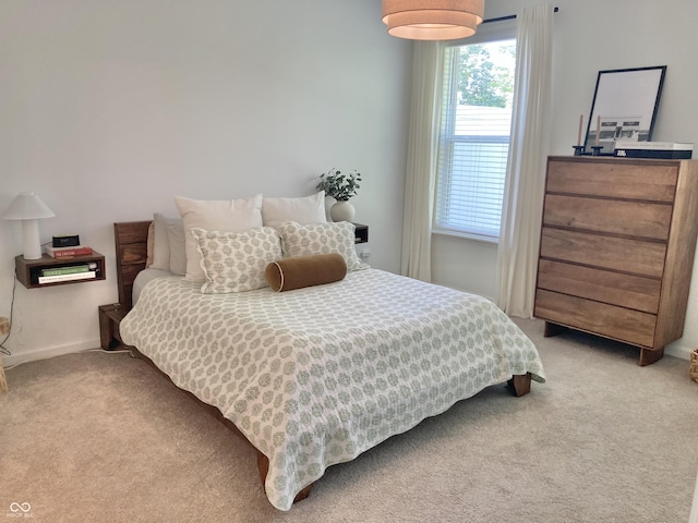 bedroom with carpet flooring and baseboards