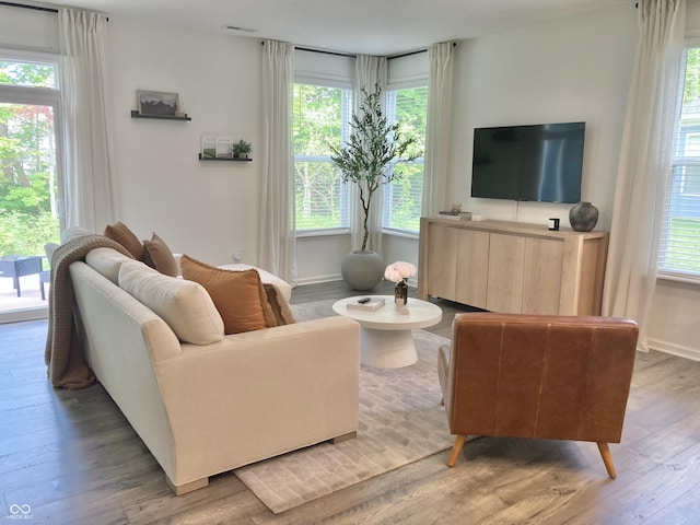 living area with wood finished floors and baseboards