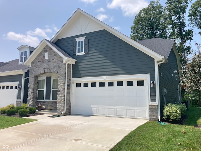 craftsman-style home with a front yard and a garage