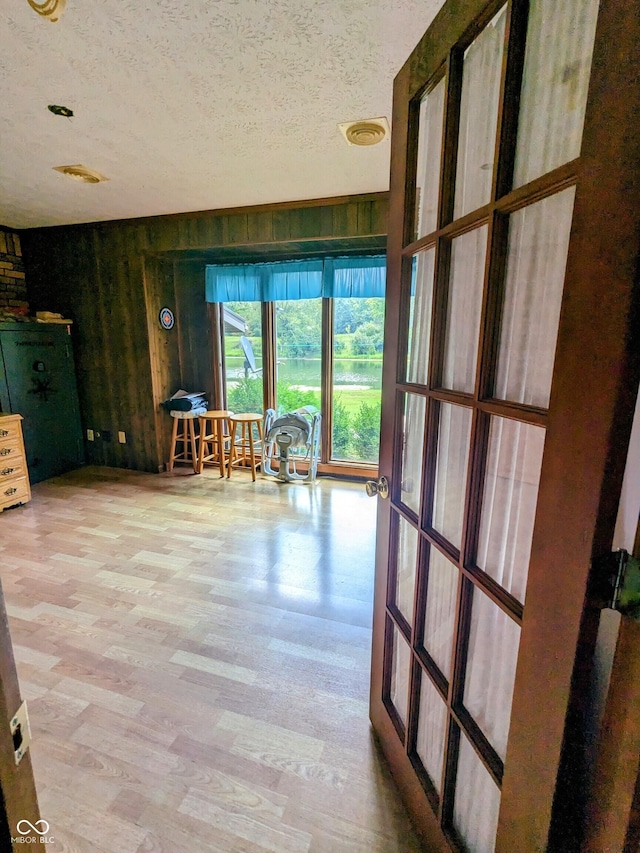 interior space featuring visible vents, wood finished floors, and a textured ceiling
