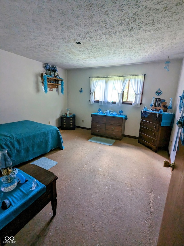 bedroom featuring a textured ceiling and baseboards