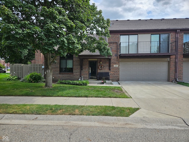 view of front of home with a garage and a balcony