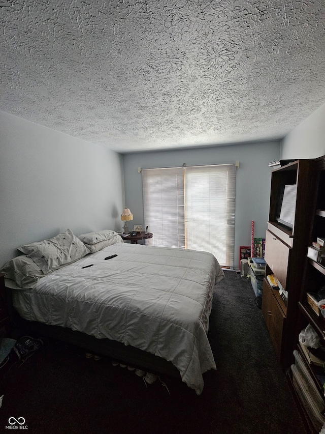 bedroom with carpet floors and a textured ceiling