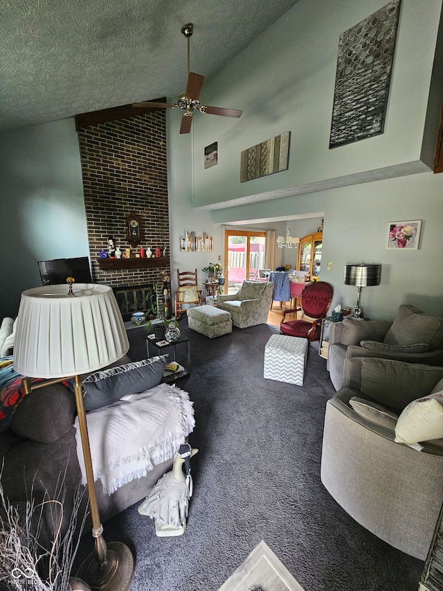 living room featuring a textured ceiling, ceiling fan, high vaulted ceiling, and a brick fireplace