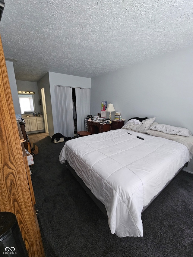 bedroom featuring a textured ceiling and carpet floors