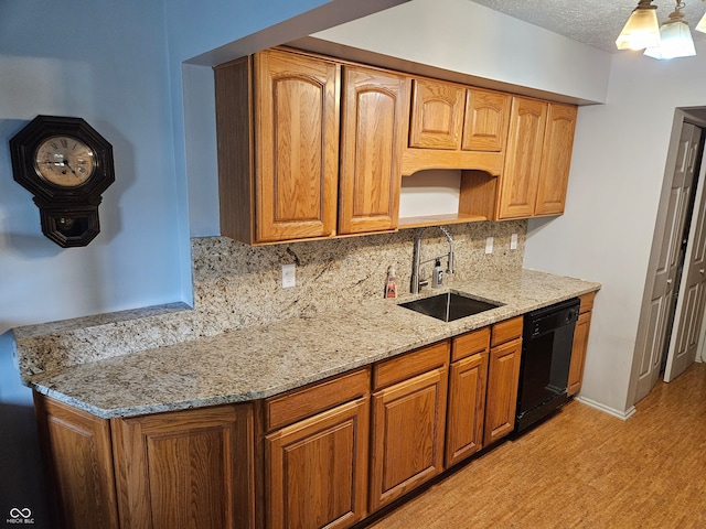 kitchen with dishwasher, decorative backsplash, sink, light stone counters, and a textured ceiling