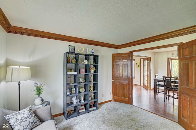 interior space with wood-type flooring, a textured ceiling, and crown molding