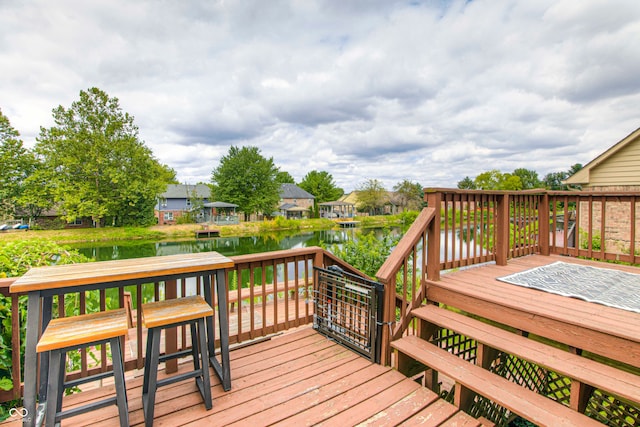 wooden terrace featuring a water view