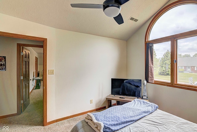 bedroom featuring ceiling fan, a textured ceiling, and carpet flooring