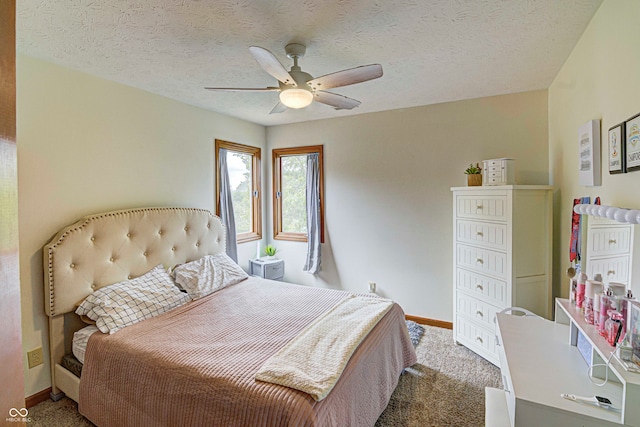 bedroom with ceiling fan, a textured ceiling, and carpet