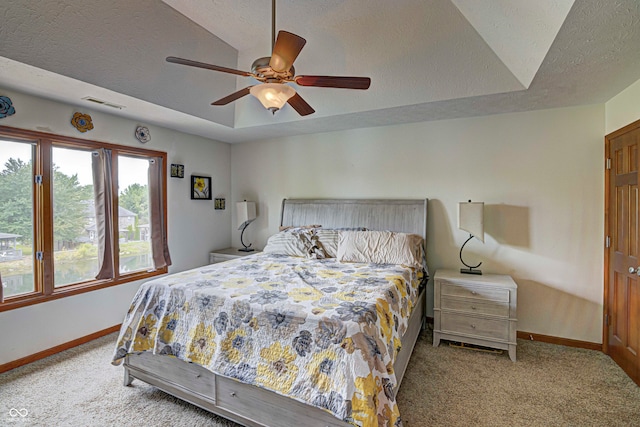 bedroom with light carpet, a textured ceiling, and ceiling fan