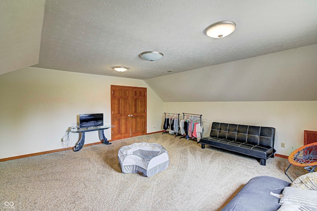 interior space with lofted ceiling, light colored carpet, and a textured ceiling