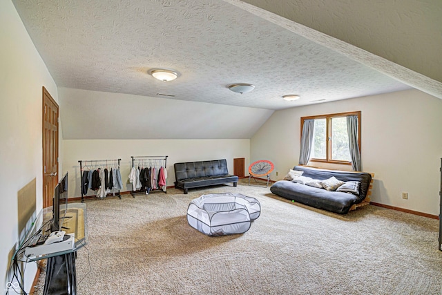 living room featuring a textured ceiling, vaulted ceiling, and light colored carpet