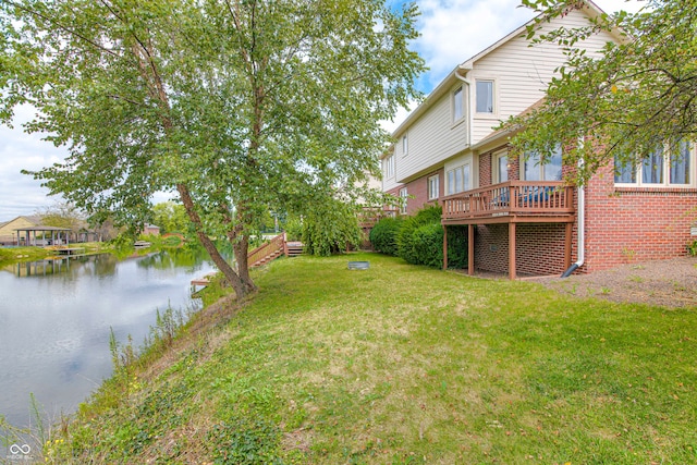 view of yard with a deck with water view