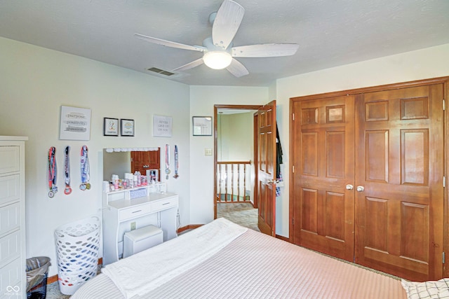 carpeted bedroom with a closet and ceiling fan