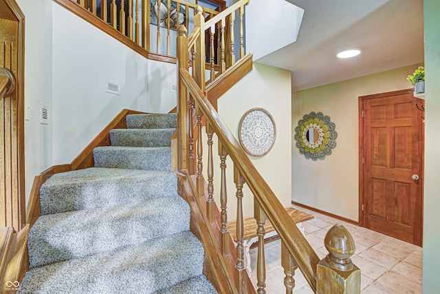 stairs featuring tile patterned flooring