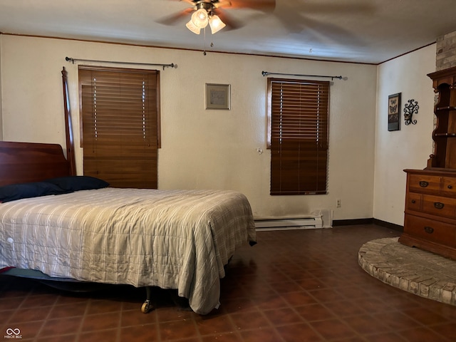 bedroom featuring ceiling fan, a baseboard heating unit, and dark tile patterned flooring