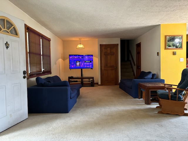 carpeted living room featuring a textured ceiling