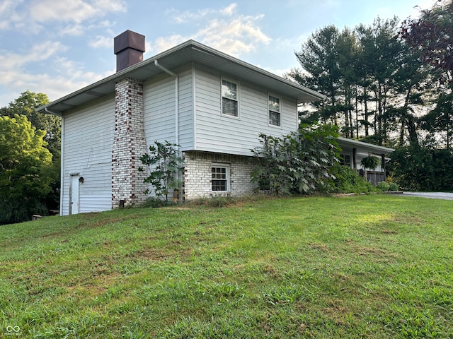 view of home's exterior with a lawn