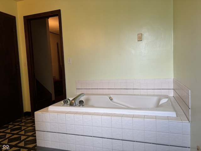 bathroom featuring tile patterned flooring and tiled bath