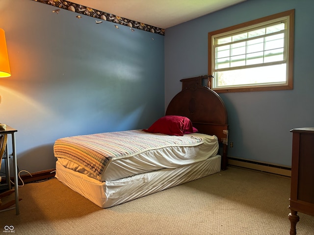 bedroom featuring carpet and a baseboard heating unit