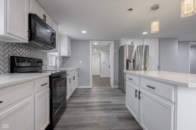 kitchen featuring a sink, decorative backsplash, black appliances, white cabinetry, and light wood-type flooring