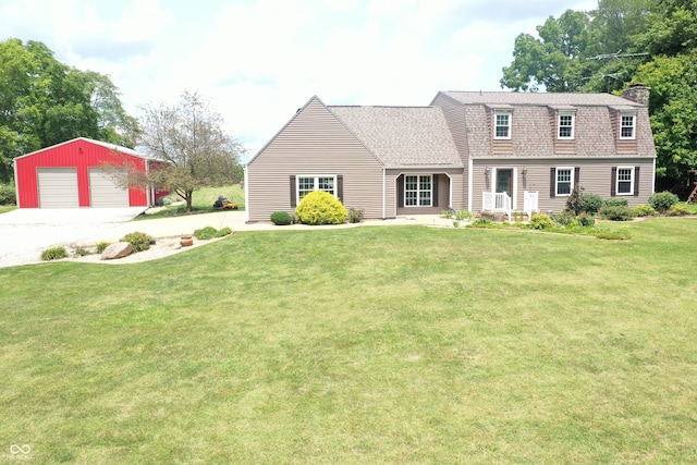 cape cod house featuring a garage, an outbuilding, and a front lawn