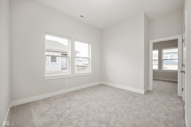 unfurnished room with light carpet