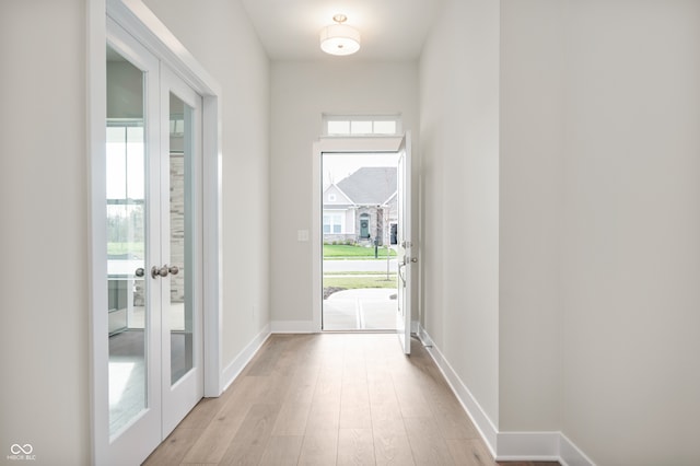 doorway to outside with french doors and light hardwood / wood-style flooring