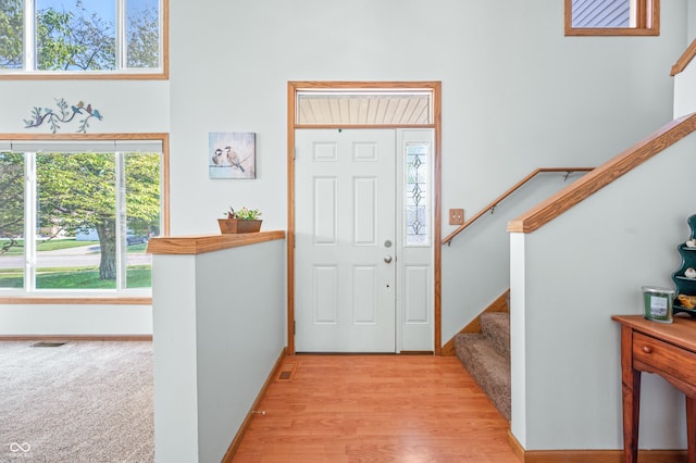 1936 Broadmoor Ln, Columbus, IN 47203 - foyer entrance with stairs, baseboards, and light wood-style flooring